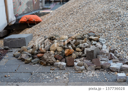 A mountain of rubble and the remains of old paving stones at a construction site 137736028