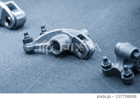 Close-up of high-precision roller rocker arm components for advanced engine valvetrain and friction reduction. 137736088