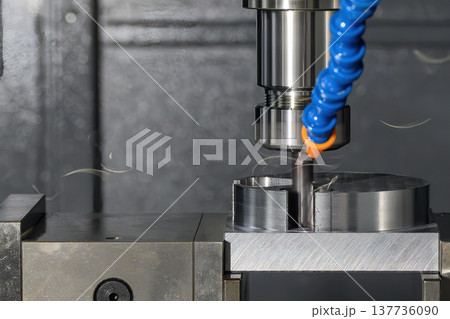 Close-up of a CNC milling machine using a flat nose end mill tool for precision metal cutting and face milling operations. 137736090