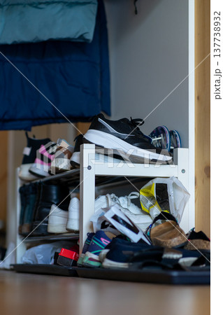 White shoe shelf filled with various shoes in a residential apartment White shoe shelf filled with various shoes in a residential apartment 137738932