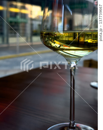 View of a glass filled with white wine standing on a restaurant table 137739667