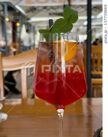 A glass of Aperol Spritz cocktail with a slice of orange and a sprig of mint A glass of Aperol Spritz cocktail with a slice of orange and a sprig of mint 137739669