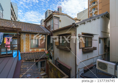Osaka, Japan - Sep 25 2024, panoramic view of narrow well courtyard with balconies facing it and back facades of living buildings, in a residential area, without people, at daytime, Osaka, Japan Osaka, Japan - Sep 25 2024, panoramic view of narrow well courtyard with balconies facing it and back facades of living buildings, in a residential area, without people, at daytime, Osaka, Japan 137739745