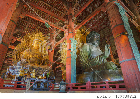 Nara, Japan - Sep 26 2024, Panoramic view of the Sitting Buddha Vairochana, a fifteen-meter bronze statue of Buddha, and a side-standing gilded statue of Buddha, at Todaiji Temple, Nara, Japan 137739812