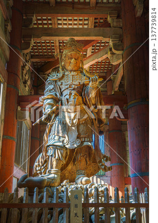 Nara, Japan - Sep 26 2024, vertical view from below of the ancient wooden statue of Komokuten, one of the two guardians of the four directions in Todaiji Temple, without people, Nara, Japan 137739814
