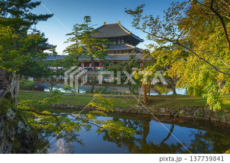 Nara, Japan - Sep 26 2024, Panoramic view across the pond and trees to the facade of Todaiji Temple, Great Buddha Hall, with a blue cloudy sky, Nara, Japan Nara, Japan - Sep 26 2024, Panoramic view across the pond and trees to the facade of Todaiji Temple, Great Buddha Hall, with a blue cloudy sky, Nara, Japan 137739841