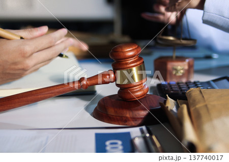 Consultation and conference of professional businesswoman and Male lawyers working and discussion having at law firm in office. Concepts of law, Judge gavel with scales of justice 137740017