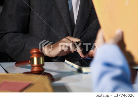 Consultation and conference of professional businesswoman and Male lawyers working and discussion having at law firm in office. Concepts of law, Judge gavel with scales of justice Consultation and conference of professional businesswoman and Male lawyers working and discussion having at law firm in office. Concepts of law, Judge gavel with scales of justice 137740020