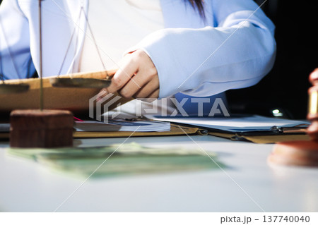 Consultation and conference of professional businesswoman and Male lawyers working and discussion having at law firm in office. Concepts of law, Judge gavel with scales of justice 137740040
