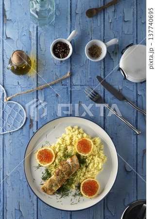Healthy salmon and couscous dinner with red caviar Healthy salmon and couscous dinner with red caviar 137740695