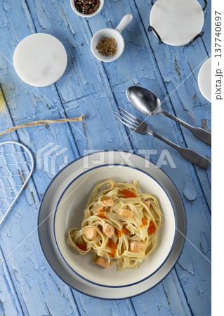 Pasta with salmon and red caviar on blue rustic table Pasta with salmon and red caviar on blue rustic table 137740697