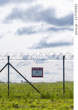 Security restricted area warning sign on fence 137740882