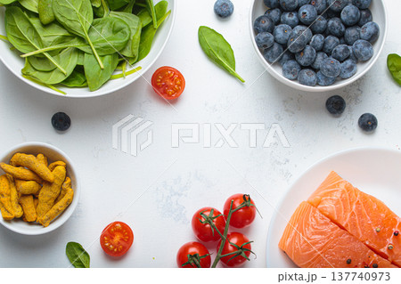 Healthy anti inflammatory diet food ingredients white background salmon blueberry spinach copy space Healthy anti inflammatory diet food ingredients white background salmon blueberry spinach copy space 137740973