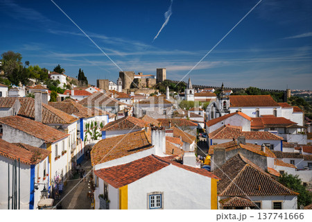 Stunning aerial view of Obidos, a medieval town in Portugal, showcasing its castle, city walls, and charming rooftops. Portugal Stunning aerial view of Obidos, a medieval town in Portugal, showcasing its castle, city walls, and charming rooftops. Portugal 137741666