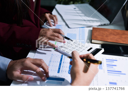 Business people analyzing monthly budget and financial report using data and chart to strategize and plan for their future business while working together in the office. Business people analyzing monthly budget and financial report using data and chart to strategize and plan for their future business while working together in the office. 137741766
