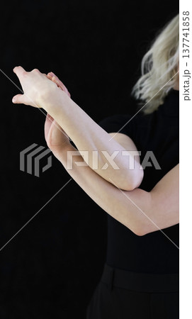 Elegant Female Hands in Graceful Gesture on Black Background 137741858