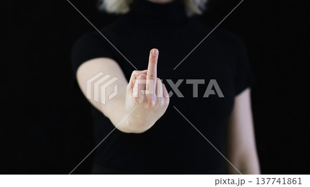 A woman's hand shows the middle finger, which signifies displeasure. 137741861
