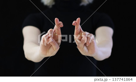 A beautiful crossed finger sign against the evil eye, from conspiracies against bad people 137741864