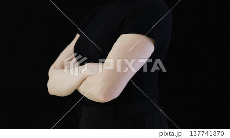 Confident Female Hand Pointing Forward in Minimal Studio Setting on Black Background, Concept of Attention and Direction 137741870