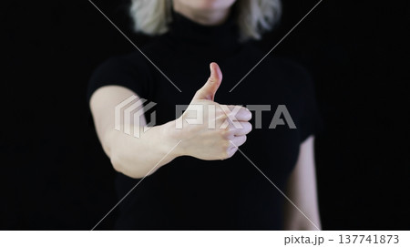 A human shows a thumbs up. Which means good. 137741873