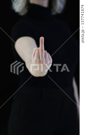 A woman's hand shows the middle finger, which signifies displeasure. A woman's hand shows the middle finger, which signifies displeasure. 137741874