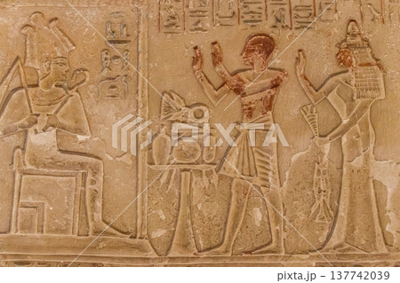 Ancient egyptian paintings and hieroglyphs carved on the stone wall Ancient egyptian paintings and hieroglyphs carved on the stone wall 137742039