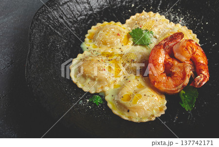 ravioli with shrimp, in cream sauce, with spices and herbs, top view, no people, 137742171