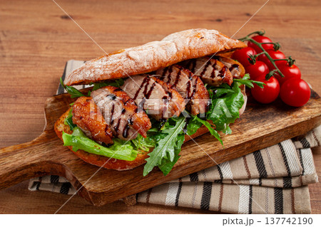 sandwich with duck breast and arugula, balsamic sauce, on a wooden chopping board, breakfast, homemade, without people, sandwich with duck breast and arugula, balsamic sauce, on a wooden chopping board, breakfast, homemade, without people, 137742190