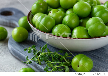 Tkemali, green cherry plum, in a bowl, on a gray table, top view, natural light, no people, Tkemali, green cherry plum, in a bowl, on a gray table, top view, natural light, no people, 137742194