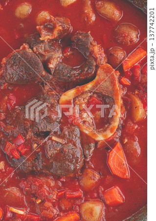 ossobuco stew with vegetables, knuckle on the bone with new potatoes, in tomato sauce,homemade, top view, no people, 137742201