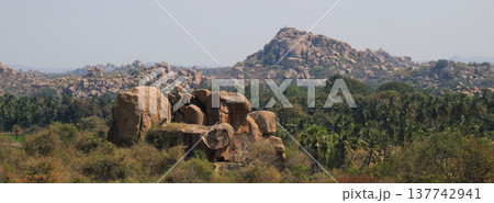 Granite boulder and peak in Hampi, India. 137742941