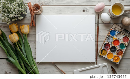 A blank white canvas on a rustic wooden table, with watercolors, flowers, and Easter decor. Concept art, education, DIY creativity, Easter decor. A blank white canvas on a rustic wooden table, with watercolors, flowers, and Easter decor. Concept art, education, DIY creativity, Easter decor. 137743435