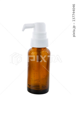 Clear amber glass spray bottle on white. 137744046