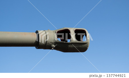 Closeup Tank Barrel Muzzle Against Blue Sky, Weathered Green Paint With Pink Ring, Visible Chipped Coating, Textured Metal Surface, Sunlight Highlighting Edges, Museum Inspection Mood 137744921