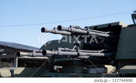 Multiple Gun Barrels On Turret Pointing Forward, Closeup Of Heavy Multibarrel Assembly With Visible Muzzles And Targeting Optics, Industrial Metal Finish And Mechanical Detail Conveying Multiple Gun Barrels On Turret Pointing Forward, Closeup Of Heavy Multibarrel Assembly With Visible Muzzles And Targeting Optics, Industrial Metal Finish And Mechanical Detail Conveying 137744990