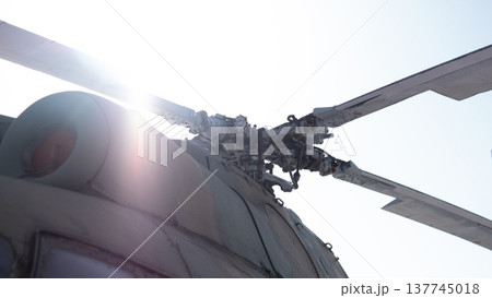 Sunlit Rotor Hub With Lens Flare, Preflight Inspection Vibe, Closeup Of Rotor Mast And Fuselage Junction, Sun Glare, Paint Wear, Mechanical Linkage, Maintenance Context, Aviation 137745018
