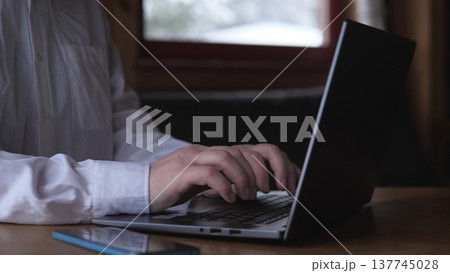 Hands Balancing Smartphone And Laptop Keyboard, White Shirt Sleeve, Multitasking With Notifications And Apps, Focused Digital Workflow, Calendar And Communication Tools Visible In Closeup 137745028