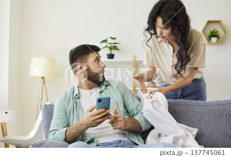 Tense Discussion on Sofa as Lipstick Mark Triggers Relationship Trust Issues Tense Discussion on Sofa as Lipstick Mark Triggers Relationship Trust Issues 137745061