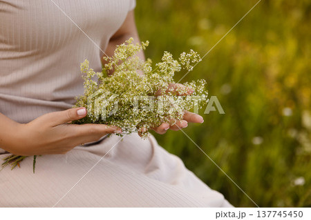 Expectant Mother Gently Enfolds Wildflower Bouquet As Sunlight Warms Her Peaceful Surroundings Expectant Mother Gently Enfolds Wildflower Bouquet As Sunlight Warms Her Peaceful Surroundings 137745450