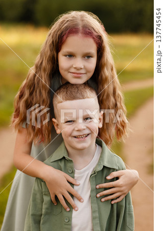 Pair Of Brothers Demonstrating Joyful Bond In Serene Outdoor Environment With Bright Smiles 137745454