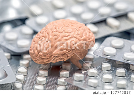 Human brain on heap of many various pills and tablets packs 137745817