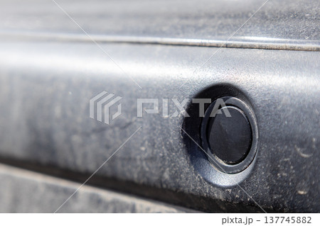 Sensors embedded in the vehicle assist drivers in parking by detecting nearby obstacles, ensuring a safer experience in crowded areas 137745882