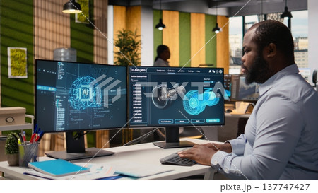 Engineer working on wind turbine simulation in office using artificial intelligence. RD department worker using AI tech and CAD program, doing renewable energy generation engineering, camera A 137747427