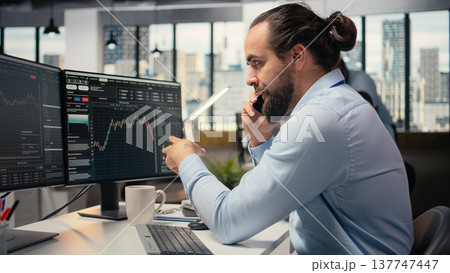 Investment consultant talking in telephone call with client, reviewing portfolio performance. Trader using smartphone to do phone call with customer, providing financial strategy 137747447