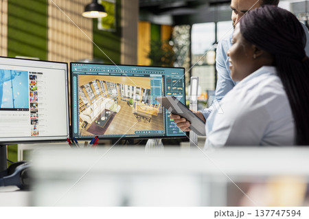 Team of designers developing digital 3D architecture model with CAD tools and software. Architect and worker uses interface to render apartment layout and prepare floor plan blueprints. 137747594