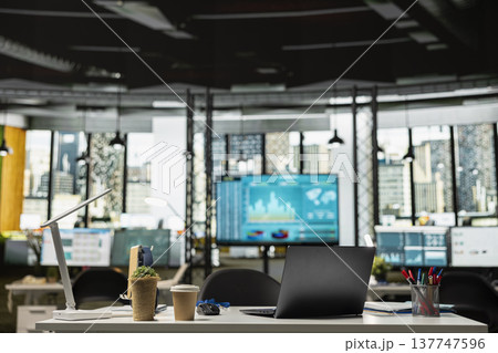 Empty office workspace with laptop on desk prepared for data analysis and strategic meetings. Unoccupied corporate workplace organized for business planning and productivity for successful startup. 137747596