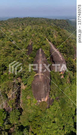 High angle view of an iconic Three Whales Rock in Thai called Hin Sam Wan a 75-million-year-old rock formation protruding out of a mountain in Phou Sing, Bueng Kan Province, Thailand. High angle view of an iconic Three Whales Rock in Thai called Hin Sam Wan a 75-million-year-old rock formation protruding out of a mountain in Phou Sing, Bueng Kan Province, Thailand. 137748978