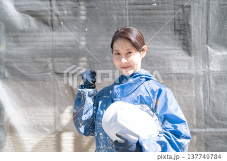建設業界で活躍するガッツポーズの女性職人 137749784