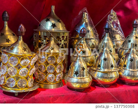 Collection of ornate brass incense burners, also known as "dhoop dani" or "incense holders. "  137750308