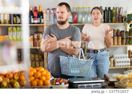 Young woman quarrels with man in grocery store Young woman quarrels with man in grocery store 137751057